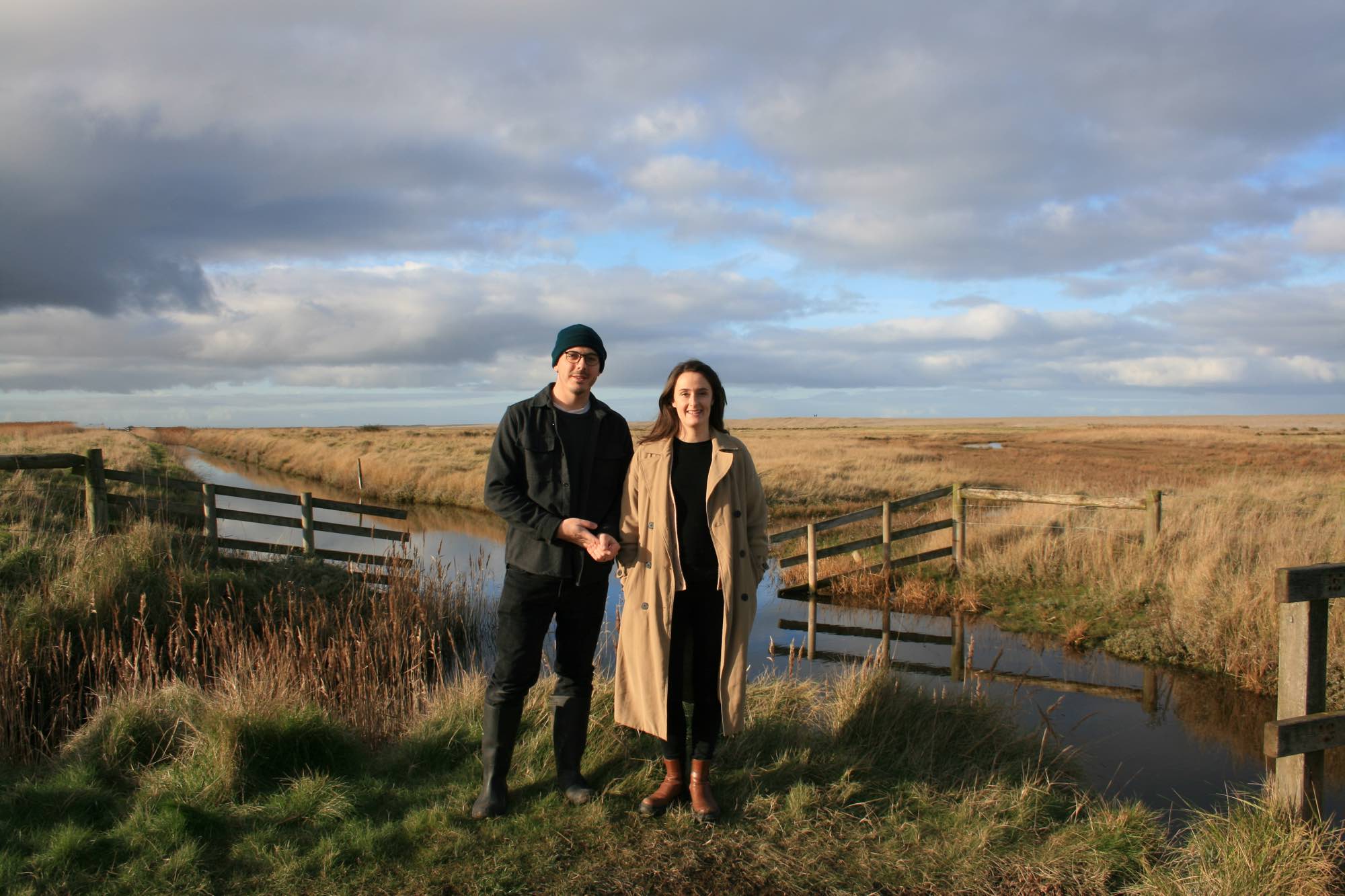 Joe and Laura Carey in a beautiful scenic grassy field