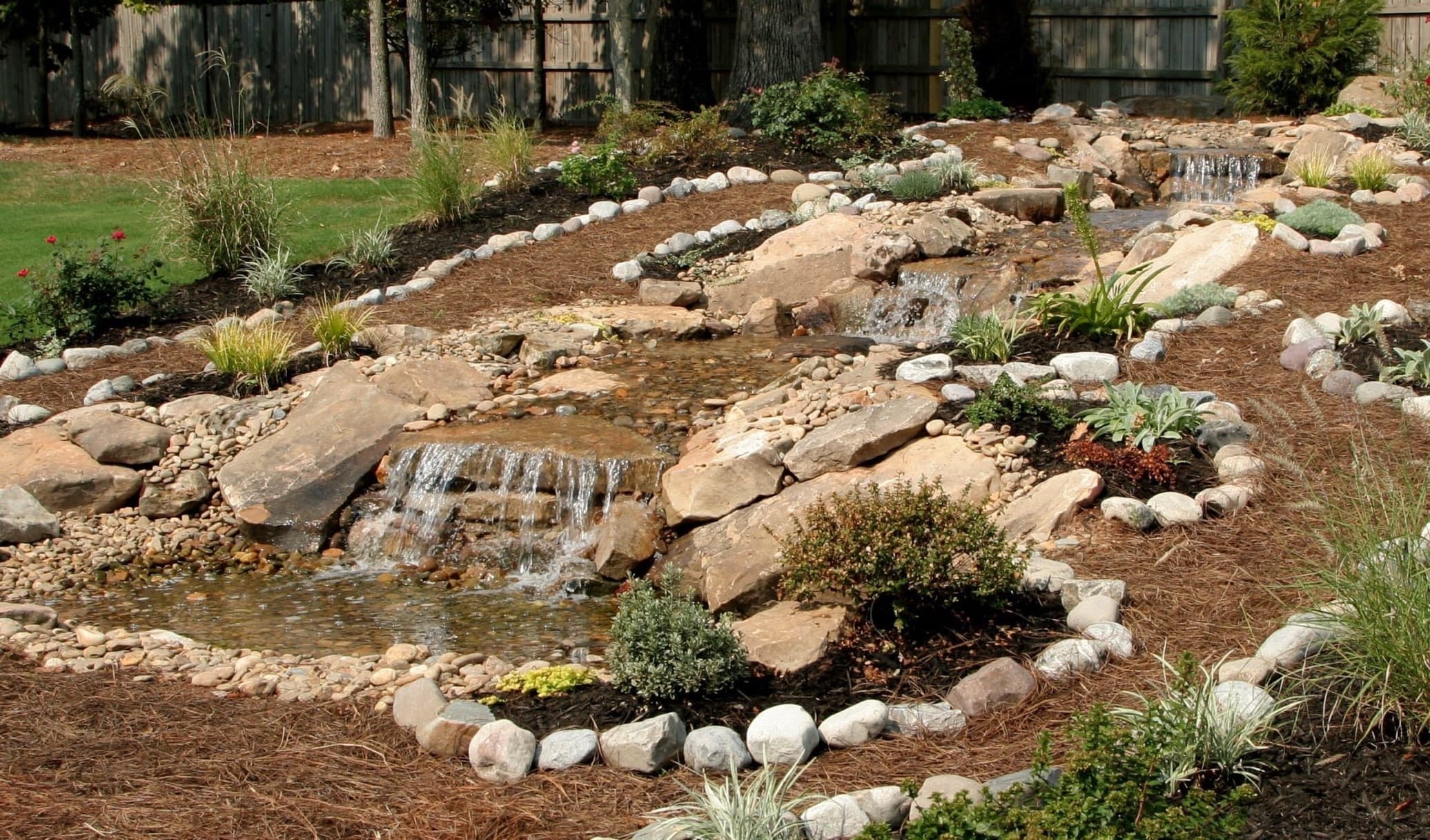 landscaped garden slope with rocks and waterfall