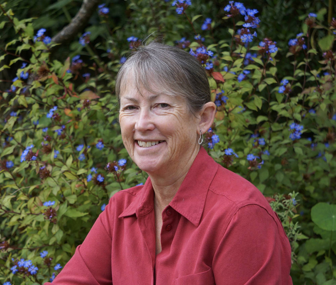 sue fisher headshot taken outside in the garden
