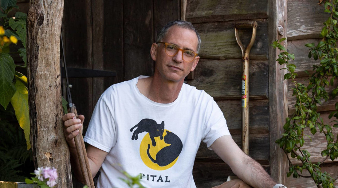 jake hobson sitting with some gardening tools outside