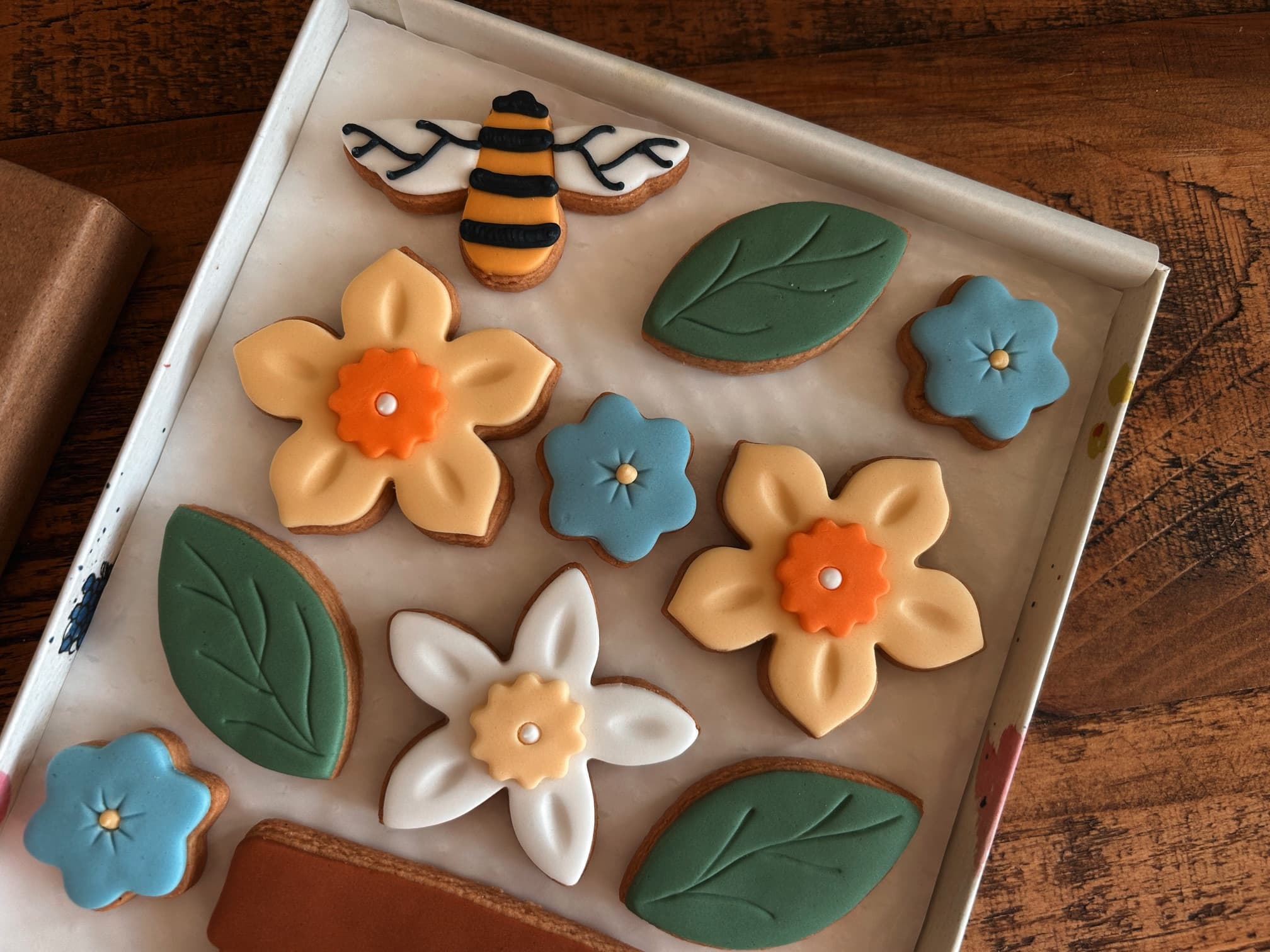 biscuits shaped and iced like flowers, leaves and bees