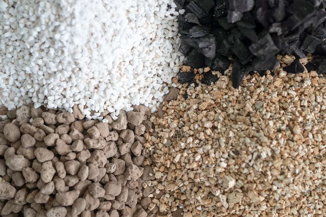 perlite, vermiculite, peat and carcoal laid out on a table