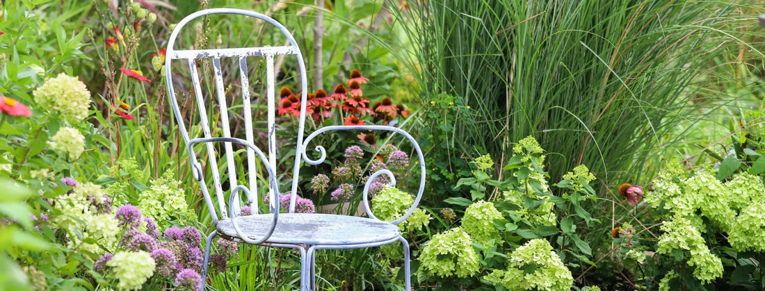 a chair in the corner of a secluded garden
