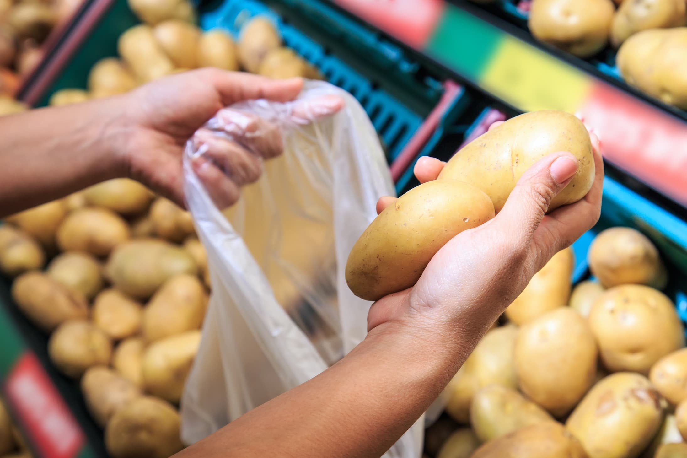 potatoes being bagged in a supermarket
