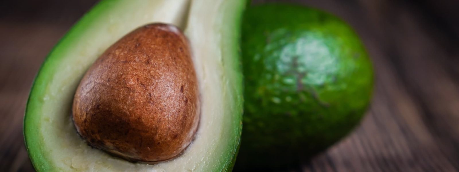an avocado sliced in half showing its stone