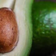 an avocado sliced in half showing its stone