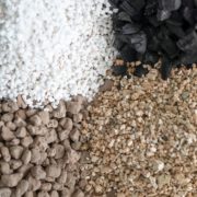 perlite, vermiculite, peat and carcoal laid out on a table