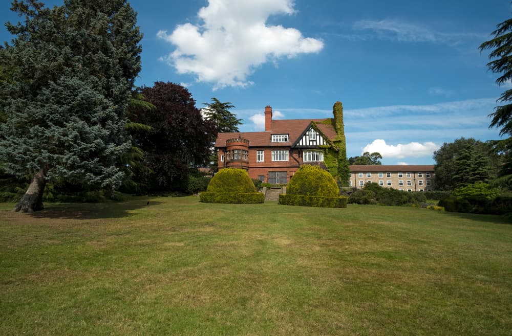large lawn in front of a big detached house