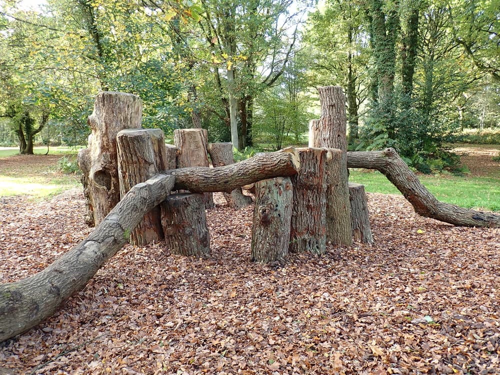 natural kids play area made from garden tree trunks