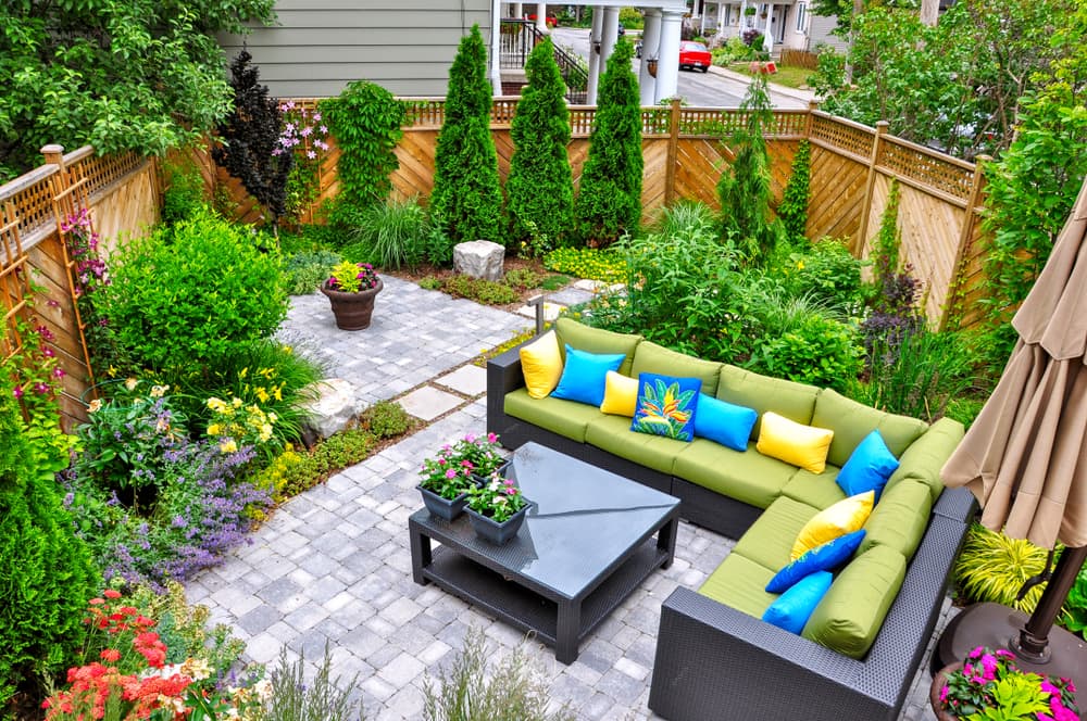 garden furniture surrounded by trees, shrubs and perennials