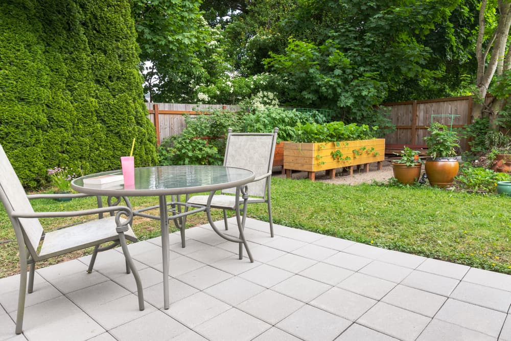 raised beds built into a garden landscape for edible yields with surrounding conifers and other trees