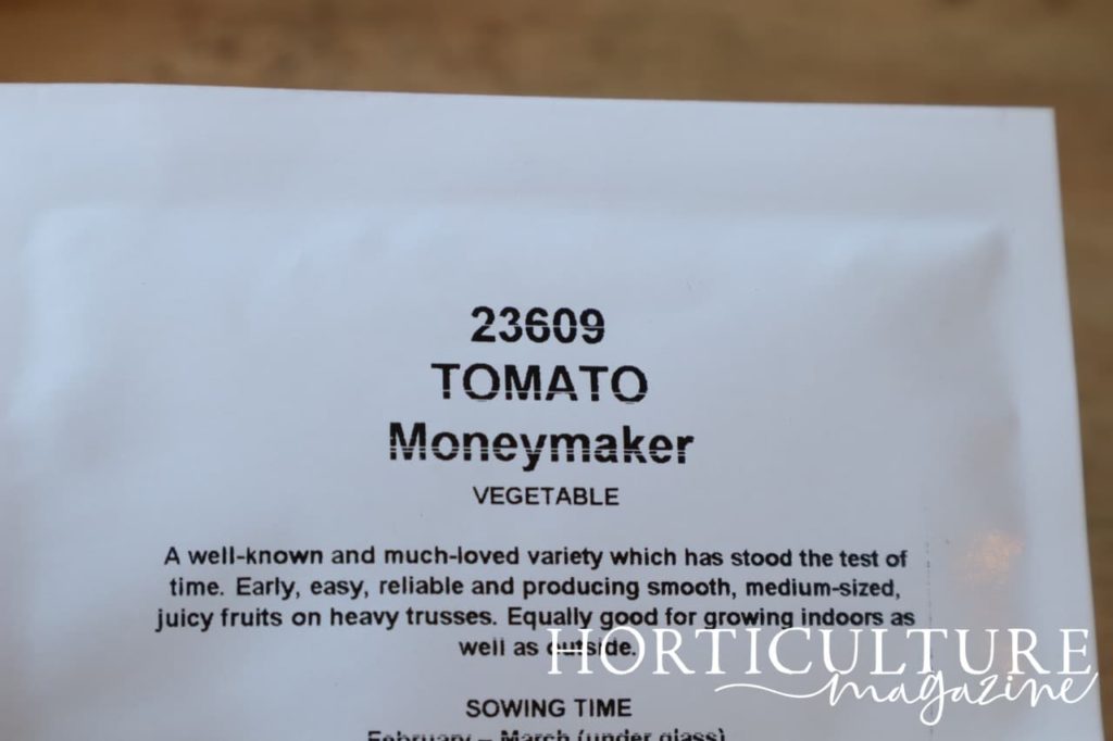seed packet that reads '23609 Tomato - Moneymaker'
