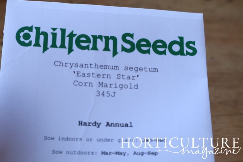 a seed packet from Chiltern Seeds with text reading Chrysanthemum segetum 'Eastern Star'