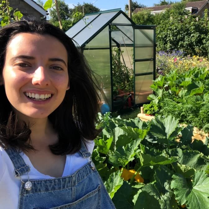 emilycupit3 emily cupit with her greenhouse and raised beds in the background