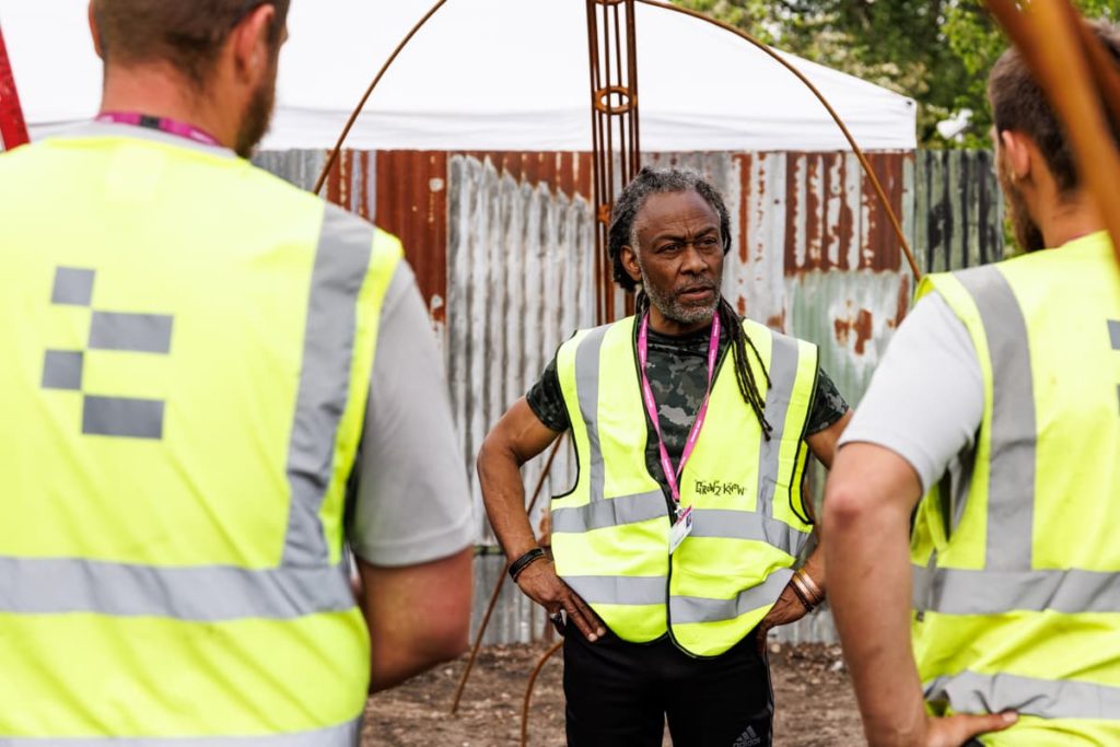 danny clarke shown speaking with a garden renovation team
