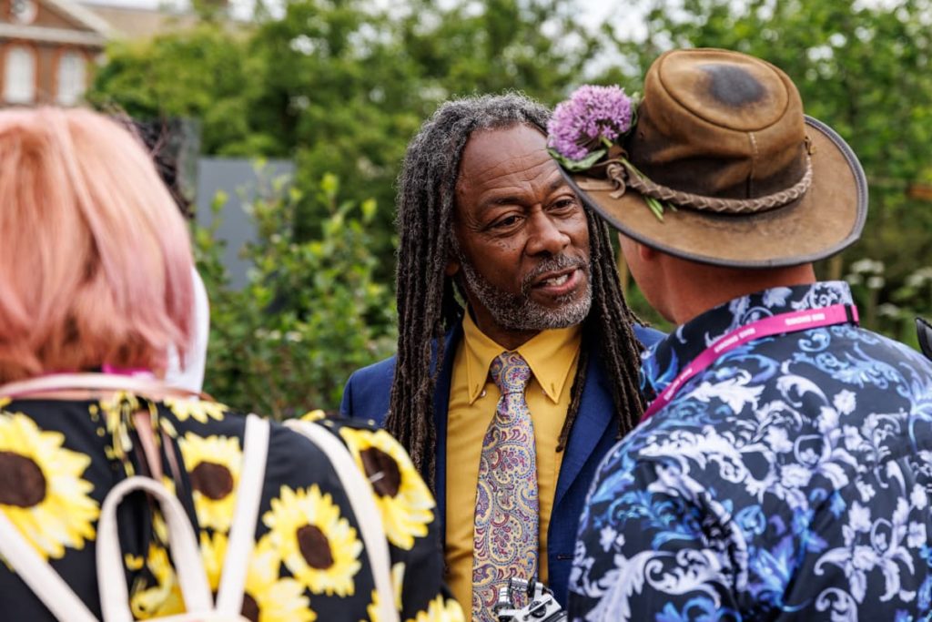 danny clarke shown speaking to guests at RHS flower show