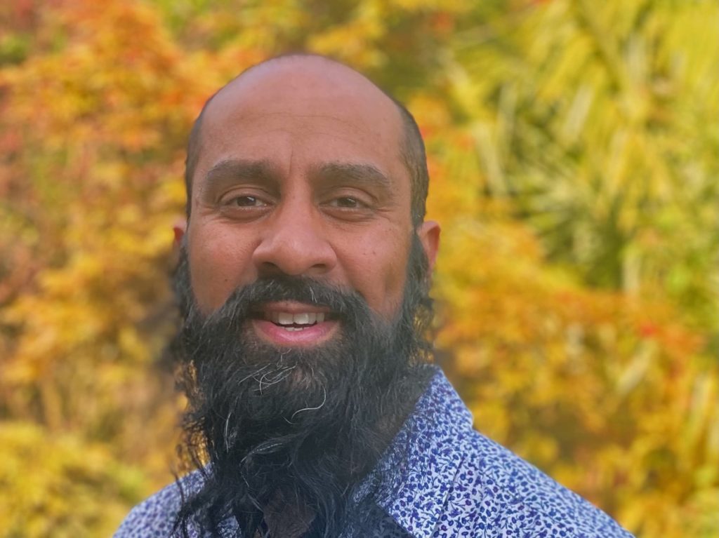 headshot of Sunil Patel with golden foliage in the background