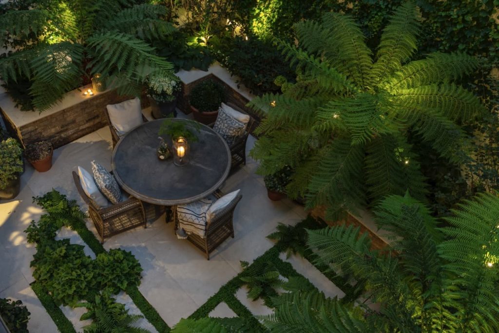 overhead image of a garden by Kate Gould with a round outdoor seated area