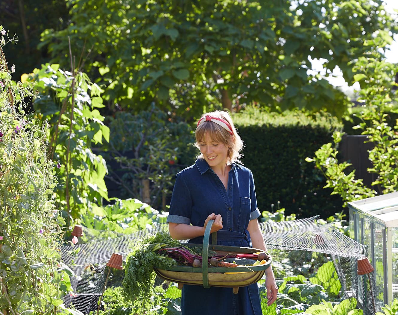 Kathy Slack in her garden harvesting vegetables