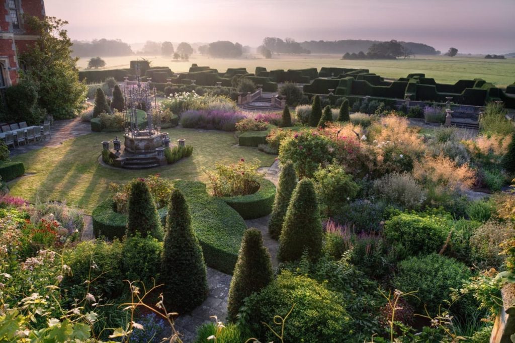 Winner of the Garden Section of the RHS photography Awards 2022 by Andrea Jones, capturing Tom Stuart-Smith's design for Madresfield Court, Worcestershire, at dawn 