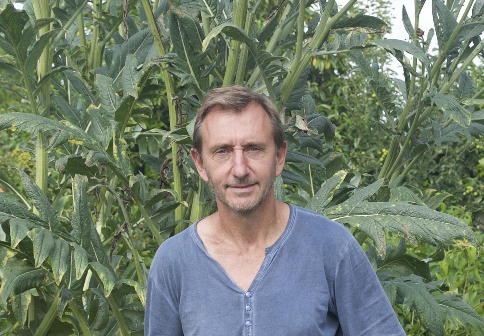 Dave Goulson in front of a leafy green background