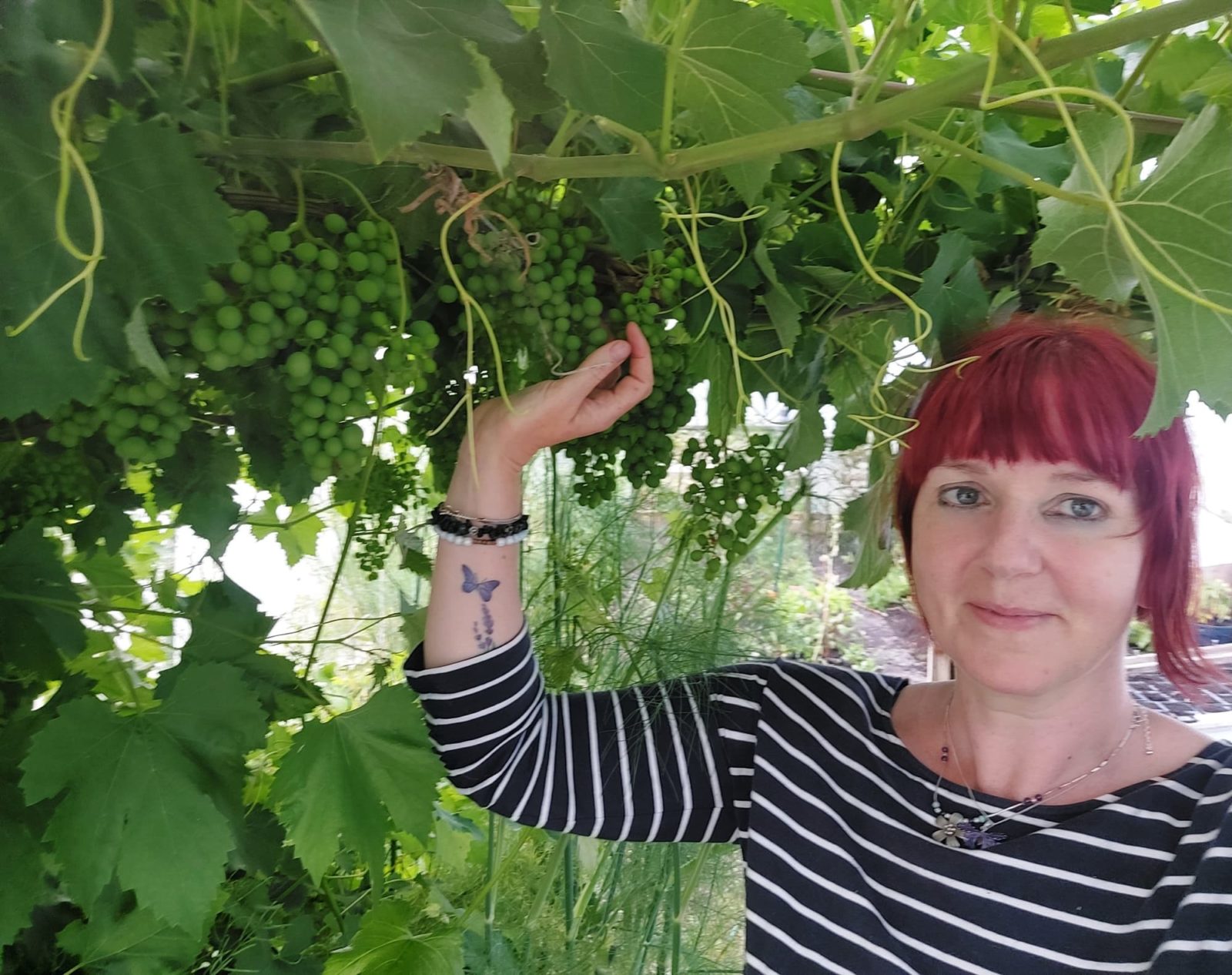 Kim Stoddart posing next to a tall tree
