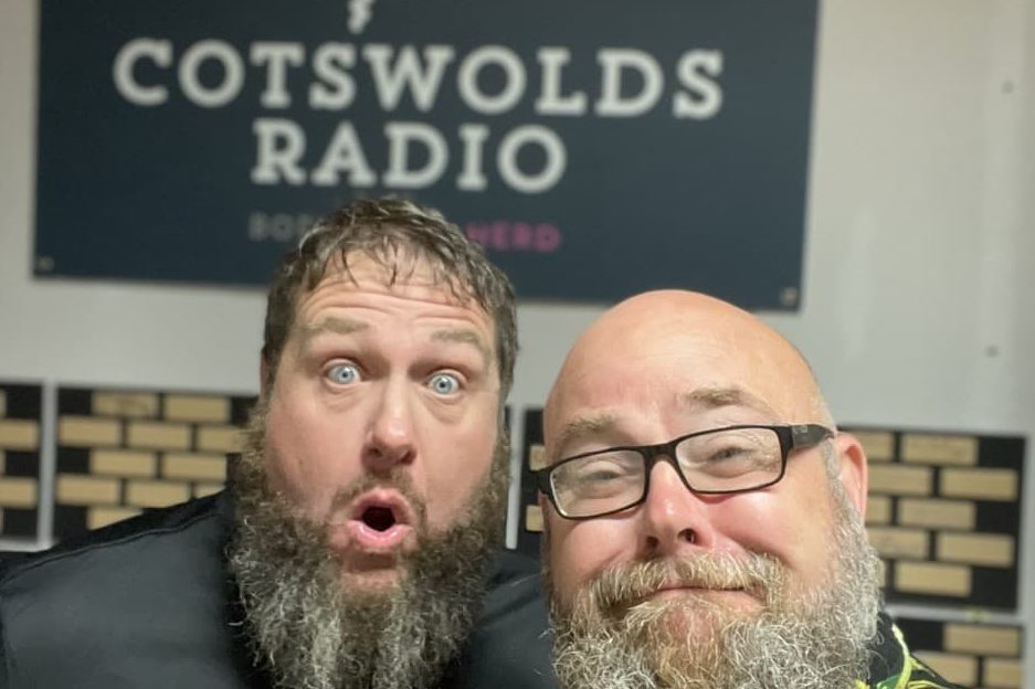 gardeners Chris & JJ in front of a sign for Cotswolds radio