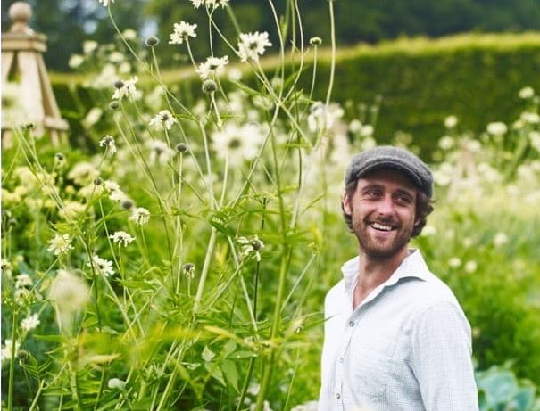 Lachlan in a wildflower meadow surrounded by tall white flowering plants