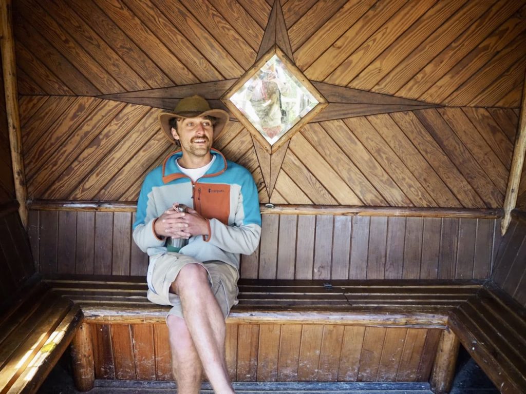 Lachlan rae sat inside a wooden building