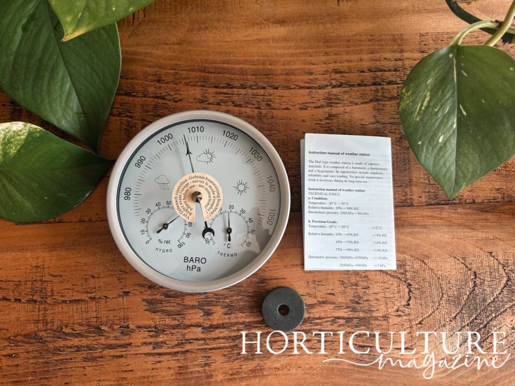 3 in 1 clock-like weather station next to its instructions