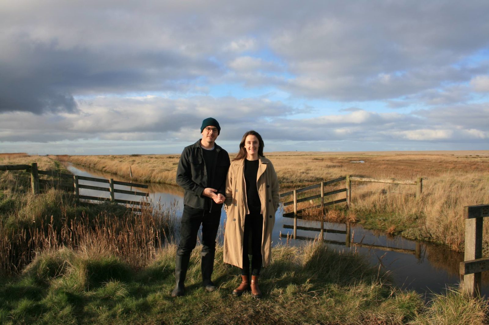 Joe and Laura Carey in a beautiful scenic grassy field