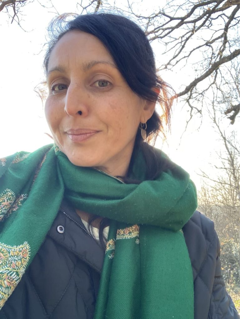 Sonya Patel Ellis in a garden on a winter's day