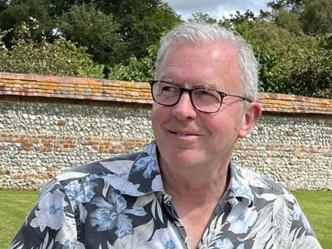 headshot of Todd Longstaffe-Gowan taken outside in front of a brick wall
