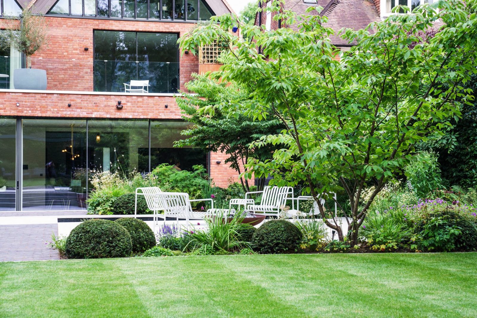 a neat lawn in front of a house designed by Tom and photgraphed by Rachel Warne