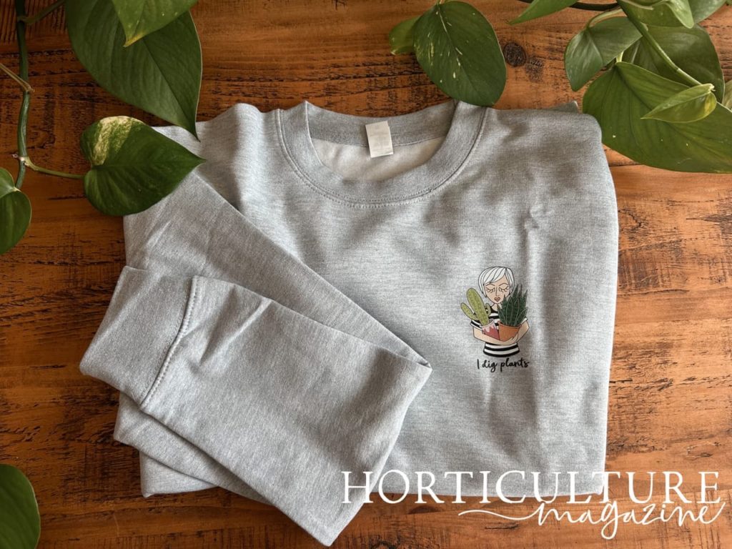 sweatshirt from syd & co in a grey colour with a small plant lady print that reads 'i dig plants'