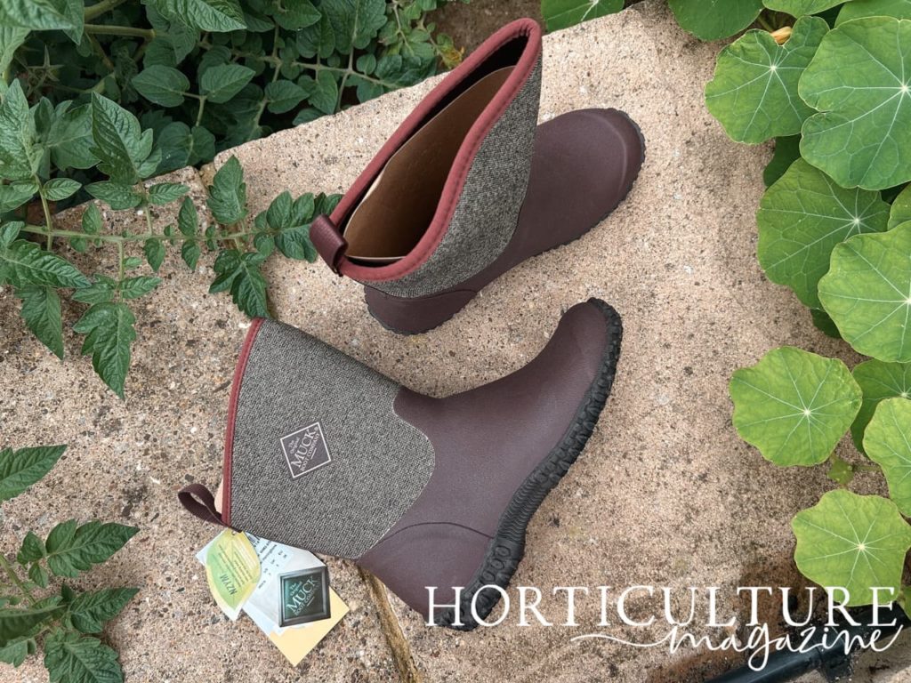 the original muck boot company's women's muckster boots on a paving stone outside