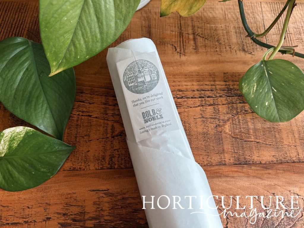 white tissue paper wrapping the black poster from bold & noble