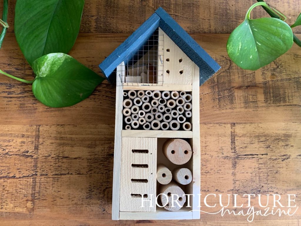 slender insect hotel from Gate 35 with blue painted roof