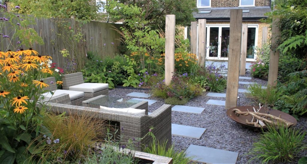 garden designed by Peter with orange rudbeckia and a seating area