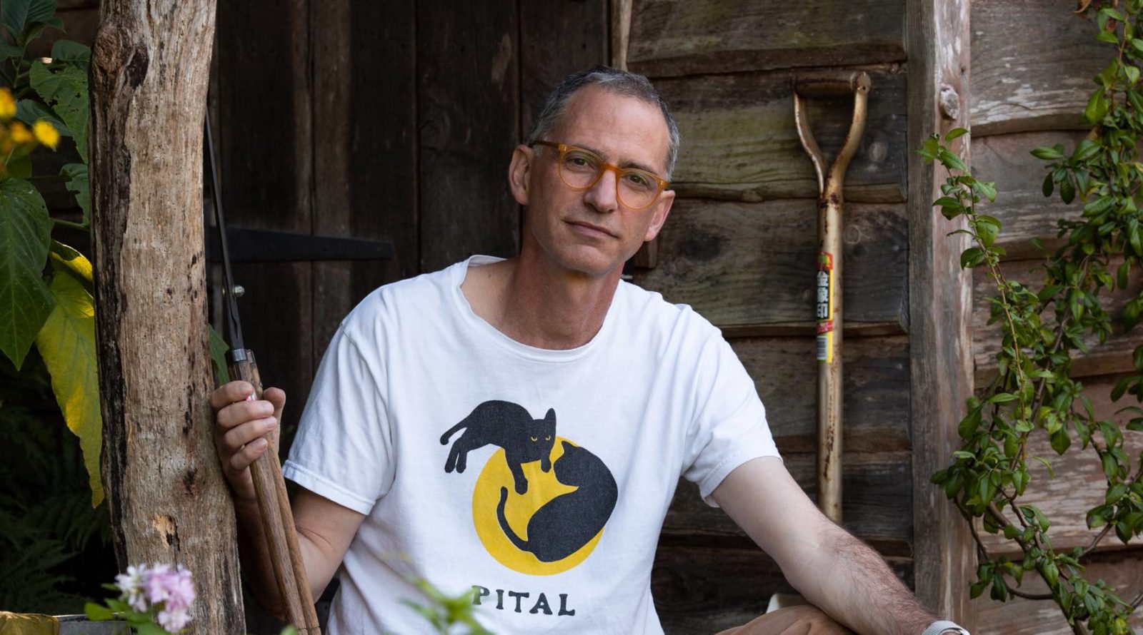 jake hobson sitting with some gardening tools outside