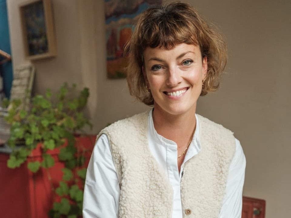 Lottie Delamain indoors with houseplants in the background