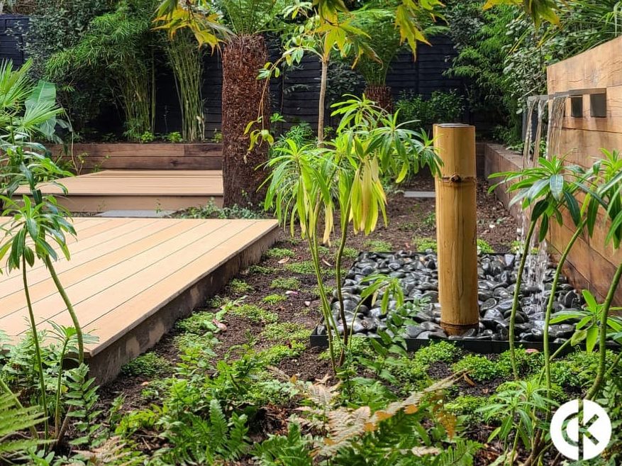 oasis garden designed by David Keegan with decking, water feature and tropical plants