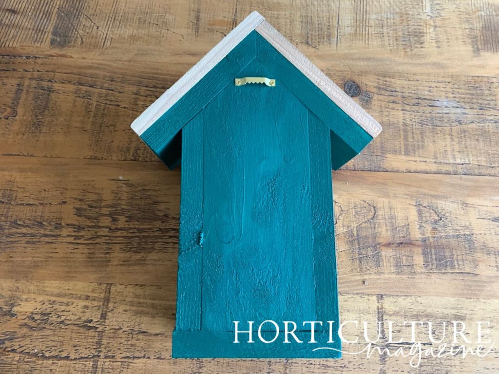 the back of a wildlife house with a golden hook at the back