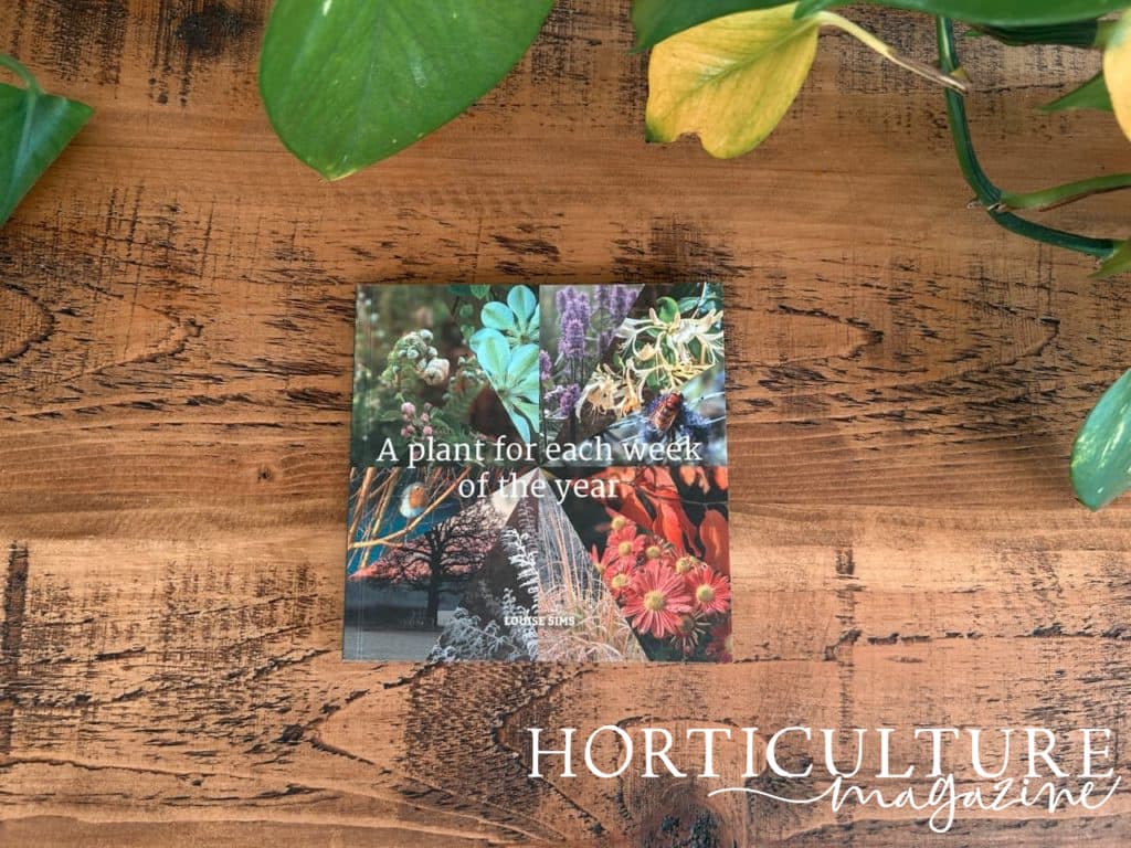 Louise Sims' book 'a plant for each week of the year' on a wooden table