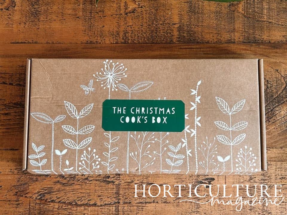 The Christmas Cook's cardboard box with lovely white floral drawings