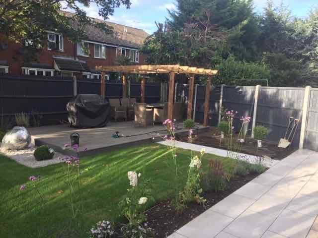 garden design with a pergola and lawned area by Jane Harries