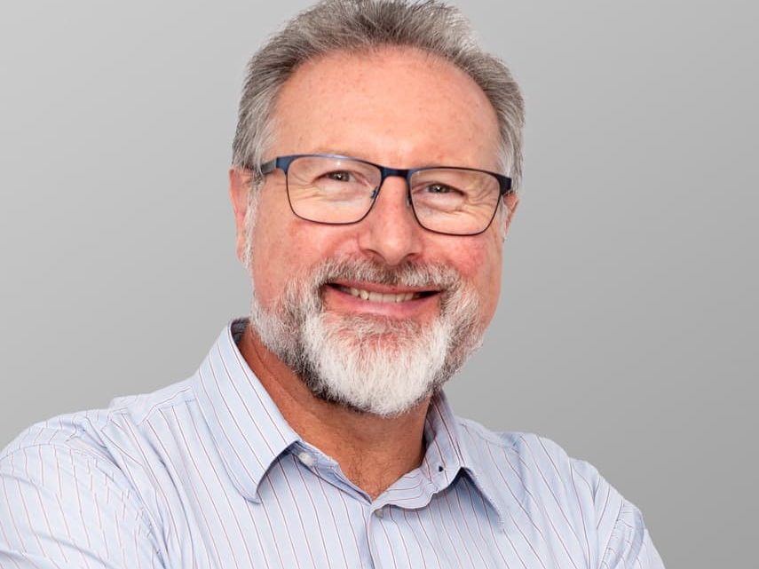 headshot taken of Toby Musgrave who is smiling and wearing glasses