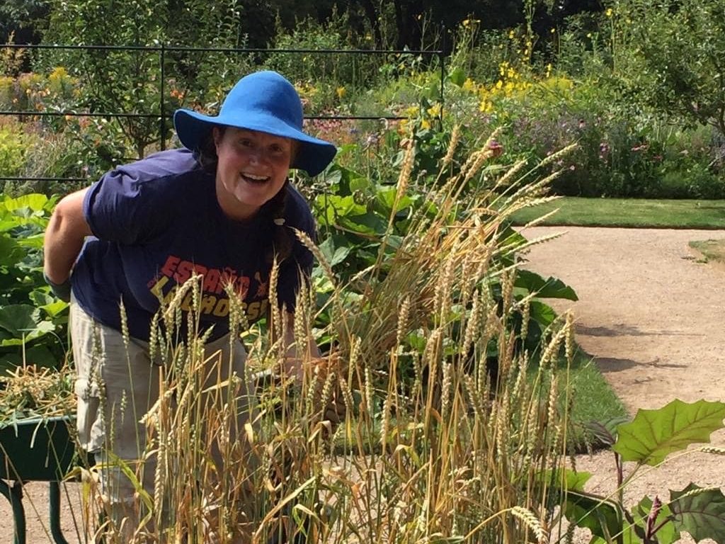 Kate Burtonwood hiding behind grassy plants in the gardens at Oxford Trinity College Gardens