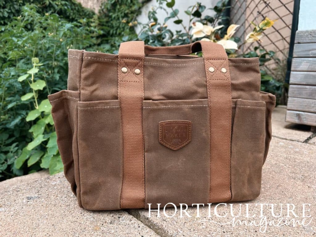 brown canvas gardening bag from life of riley on a patio outside