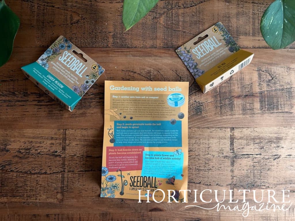 the instructions for the seed balls next to two packets from Seedball UK